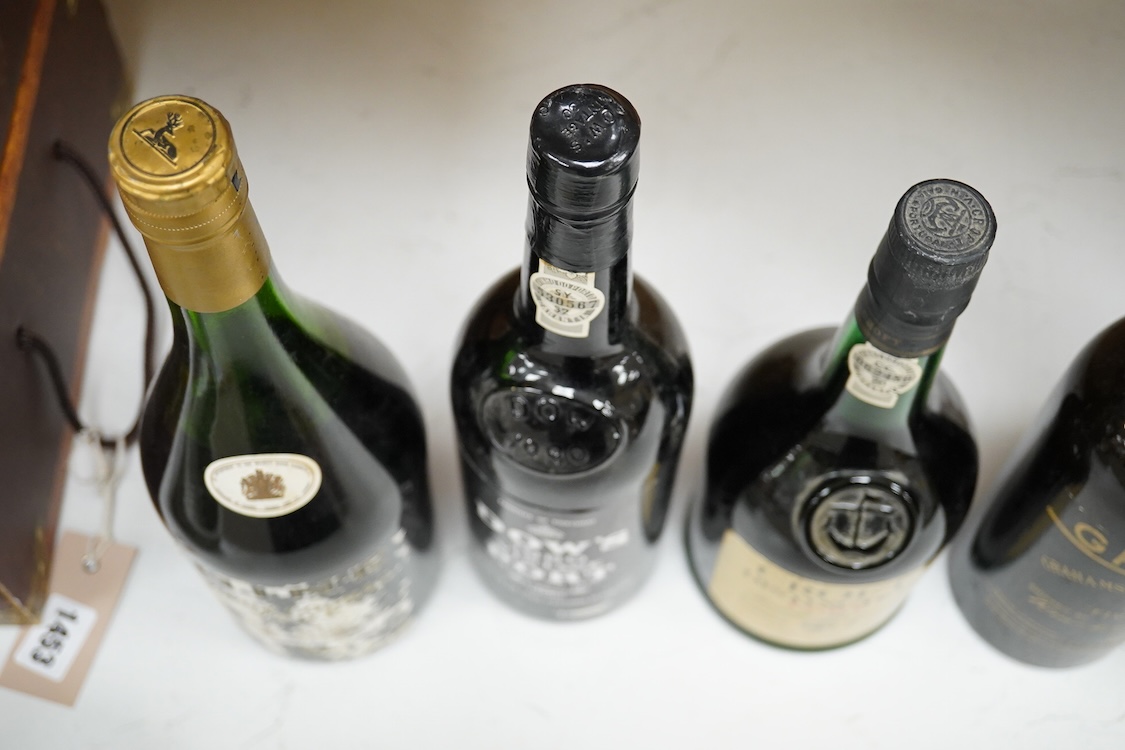 Five bottles of port and brandy, including a bottle of Dow’s 1980 bottle of port